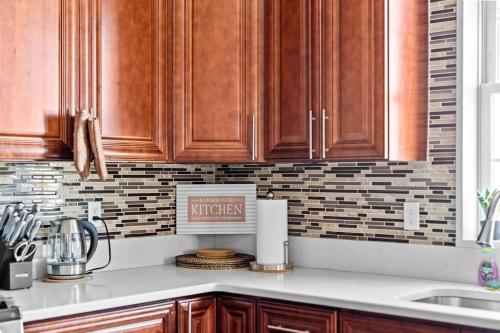 a kitchen with wooden cabinets and a counter top at 555-2 6BR Quincy - Spacious Apt near Perry Beach in Quincy