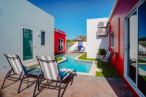 a patio with chairs and a swimming pool at Trankilidad Apartments in Santa Cruz