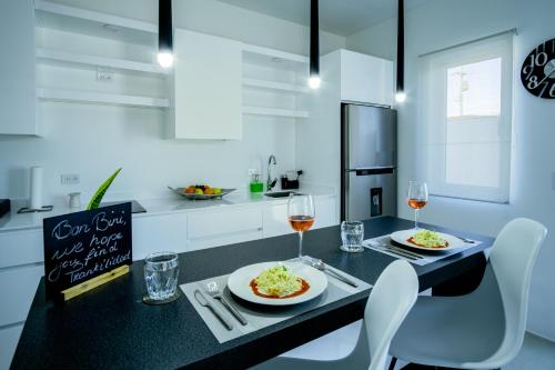 a kitchen with a table with two plates of food at Trankilidad Apartments in Santa Cruz