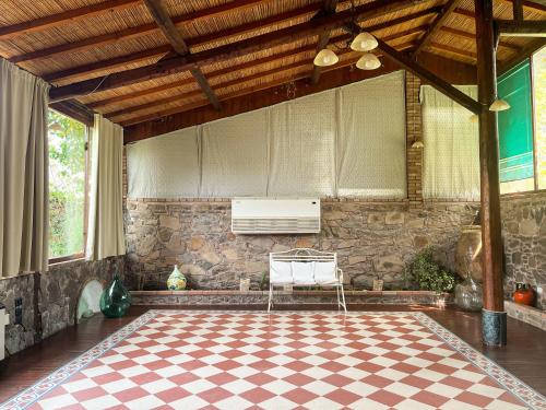 a room with a checkered floor and a white chair at Sa Mola in Bonarcado