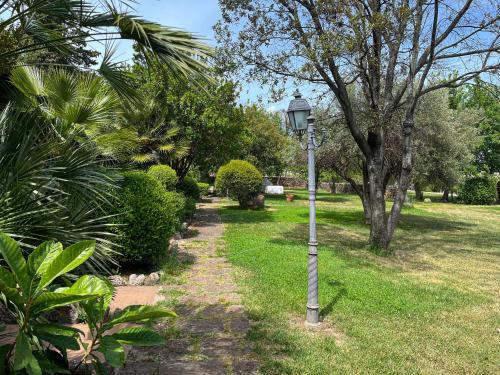 a street light in a park with trees and grass at Sa Mola in Bonarcado