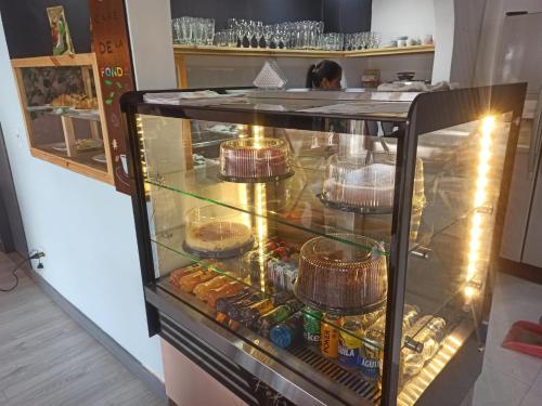 a display case in a kitchen with food in it at Hotel Mont Blanc in Circasia