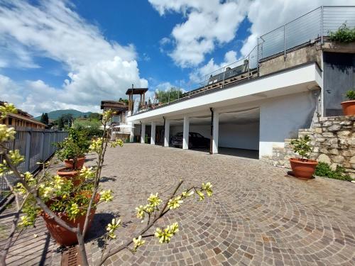 a courtyard of a building with potted plants at Pizzocolo resort fasano in Gardone Riviera