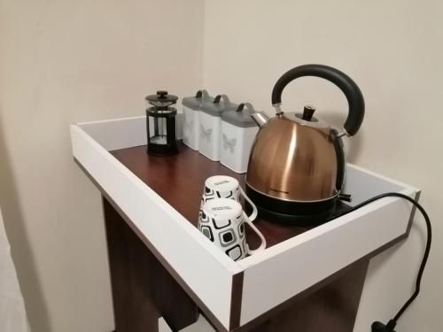 a shelf with a tea pot and other items on it at Villa Pretoria in Pretoria