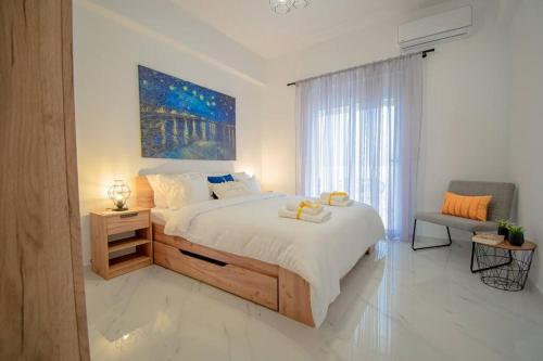 a bedroom with a large bed and a large window at Fileo Family and Friends Living in Archangelos