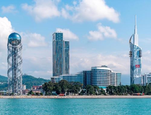 a city skyline with tall buildings and a beach at Angel Apartment in Porta Batumi in Batumi