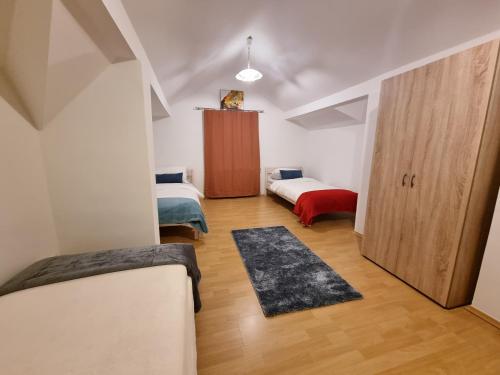 a small room with two beds and a closet at Workers Home Salzburg in Salzburg