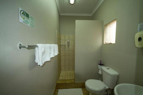a bathroom with a toilet and a shower at @ Marula in Mokopane