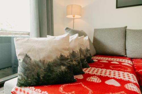 a pillow with a picture of a forest on a couch at CABANA BERNER stațiunea Mogoșa in Baia-Sprie