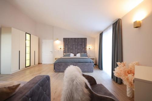 a bedroom with a bed and a dog in a room at Castello Exclusive rooms with breakfast - by TA Leut Agency in Privlaka