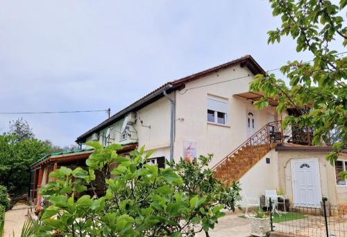 a house with a staircase on the side of it at STUDIO APP & Beauty Loza in Zambratija