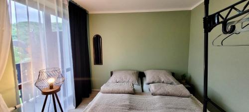 a bedroom with two beds in front of a window at Studio 2-pokojowe z balkonem z widokiem na góry in Międzybrodzie Żywieckie