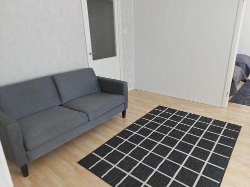 a living room with a couch and a rug at Kiertokatu apartment in Pori