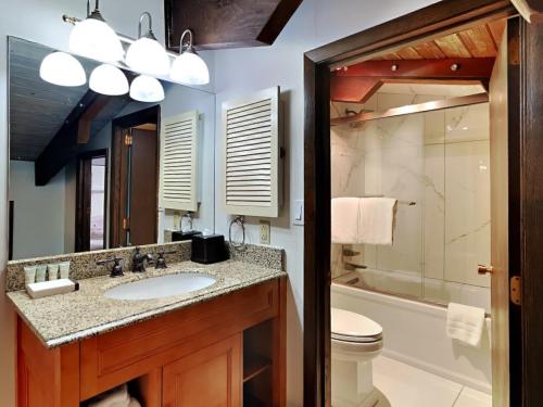 a bathroom with a sink and a toilet and a mirror at Timberline Condominiums 1 Bedroom plus Loft Deluxe Unit B3C in Snowmass Village