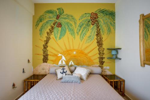 a bedroom with a bed with palm trees painted on the wall at Harmony villa in Sivota