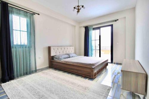 a bedroom with a bed and a large window at Villa Joven; Ödüllü Bir Sitede Havuzlu 4+1 Villa in Çeşme