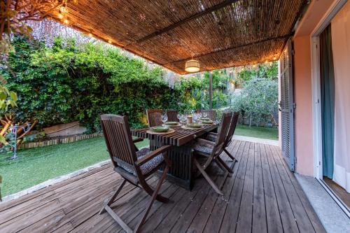 a wooden deck with a table and chairs on it at H11 COUNTRY LUX - Sanremo - Garden in Sanremo