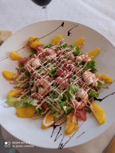 a plate of food with a salad on a table at Hostal Restaurante La pinta in Ampuero