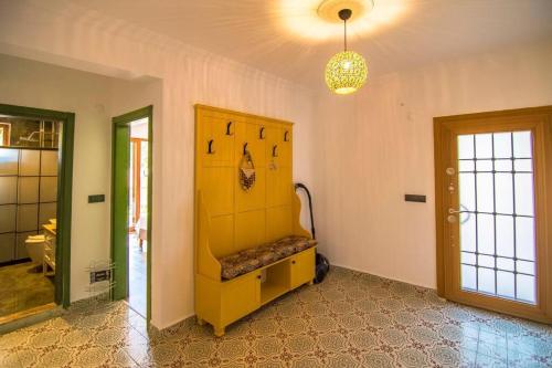 a room with a yellow shelf and a door at Kayaköyde Havuzlu Bahçeli Villa in Fethiye