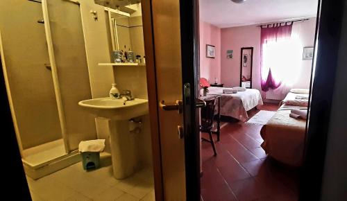 a bathroom with a sink and a room with a bed at Cà D' Rot - Casa Ratti in Vinchio