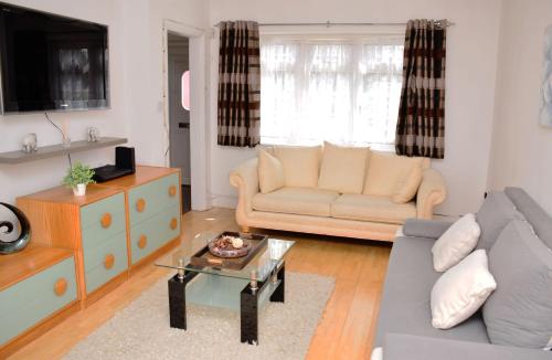 a living room with a couch and a coffee table at 29EW Dreams Unlimited Serviced Accommodation- Staines - Heathrow in Stanwell