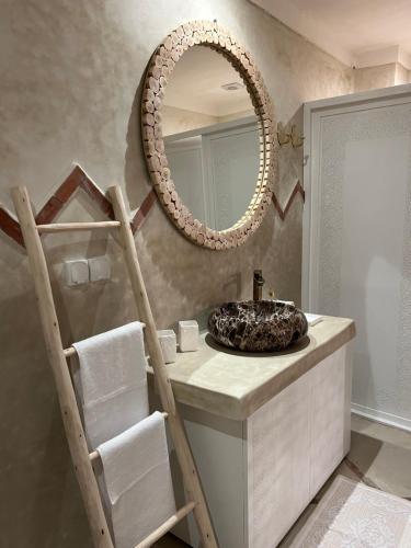 a bathroom with a sink and a mirror at Riad Tsar Mimoun in Marrakesh