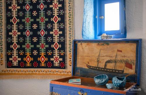 a painting of a ship on a wall with a window at Leros Windmills in Panteli