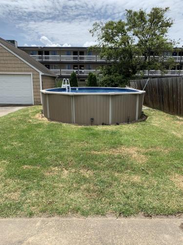 a swimming pool in a yard with a building at Bay View Bungalow by the Pier home in Norfolk