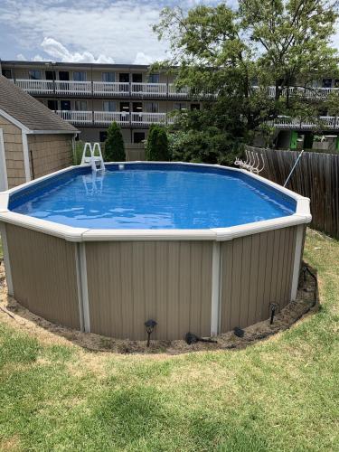a large swimming pool in a yard with a building at Bay View Bungalow by the Pier home in Norfolk