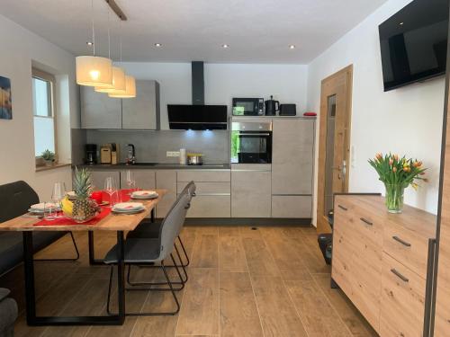 a kitchen and dining room with a table and chairs at Appartement Dorfblick in Auffach