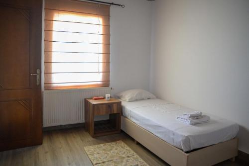 a small bedroom with a bed and a table at Villa Antigoni in Megáli Vrísi