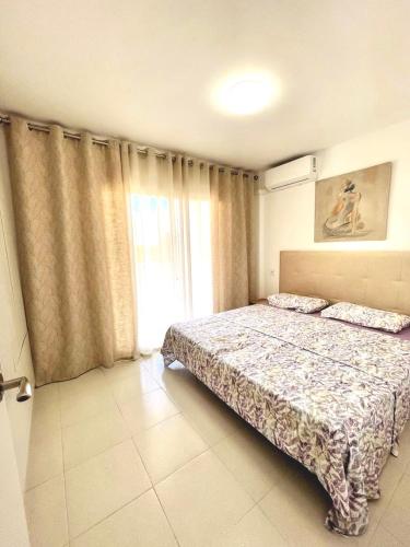 a bedroom with two beds and a large window at Royal in Salou