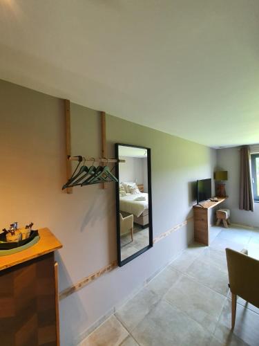 a living room with a mirror and a bedroom at Q-time Barvaux, Durbuy-Adults Only in Durbuy