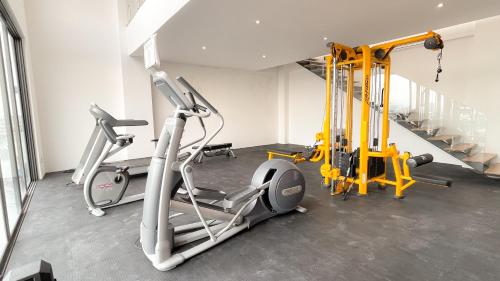 a gym with two exercise bikes and a treadmill at Amerittania 402 in Guadalajara