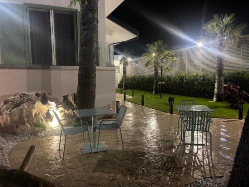 a patio at night with a table and chairs at I-relais b&b in Montefalcone del Sannio