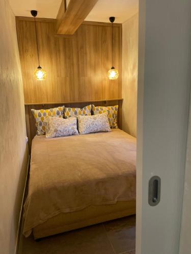 a bedroom with a bed with two pillows at Seashell Hideaway Apartment in Pržno