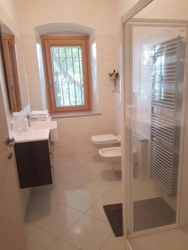 baño con 2 aseos y ducha acristalada en Villa Montegolo, en Costermano