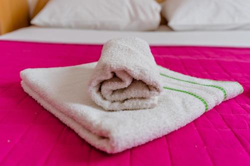 a white towel is sitting on a bed at Pansion Milena i Mario in Međugorje