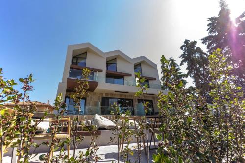 a building with trees in front of it at ACRO Upscale Residences in Kórinthos