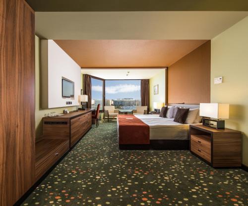 a hotel room with a bed and a large window at Boutique Hotel Victoria Budapest in Budapest