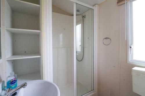 a bathroom with a shower and a white sink at 3 Bed, 8 Berth Caravan For Hire At St Osyth Park Near Clacton-on-sea Ref 28039cw in Clacton-on-Sea