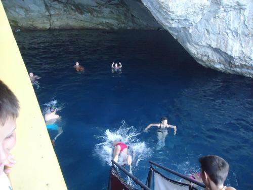 a group of people in the water in a cave at Homer Studio in Nydri