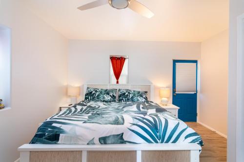 a bedroom with a bed with a blue and white comforter at Crescent Moon Casita, 2 Bedrooms, Patio, WiFi, Sleeps 4 in Santa Fe