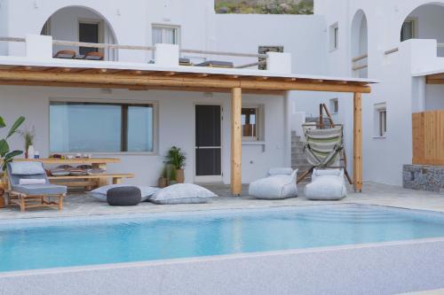 a villa with a swimming pool and a house at Vouno Luxury Villas in Glinado Naxos