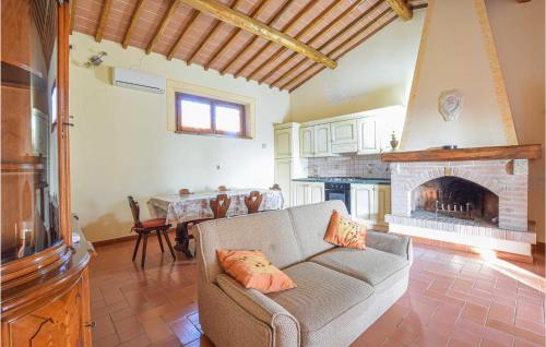 a living room with a couch and a fireplace at Casa Giannini in Magliano in Toscana