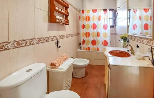 a bathroom with a white toilet and a sink at 4 Bedroom Lovely Home In Almchar in Almáchar