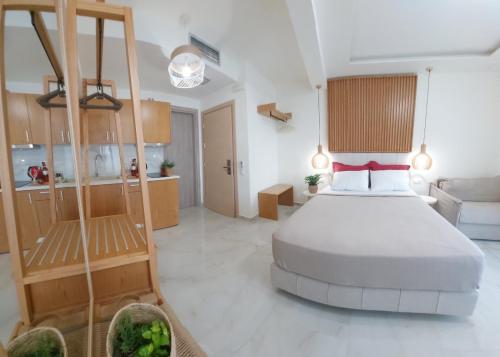 a bedroom with a large bed and a kitchen at Wide Blue Luxury Boutique Suites in Neos Marmaras