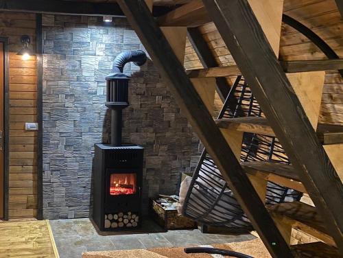 a fireplace in a room with a brick wall at Vikendica Aview in Štrpce