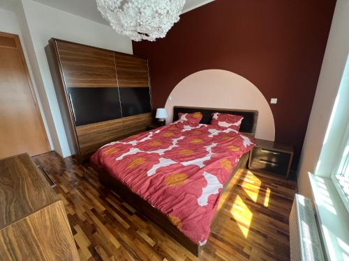 a bedroom with a bed and a chandelier at Condo Casa Di Olivia in Maribor