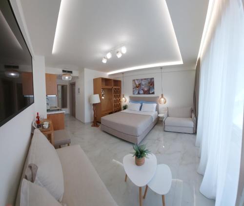 a large living room with a bed and a couch at Wide Blue Luxury Boutique Suites in Neos Marmaras